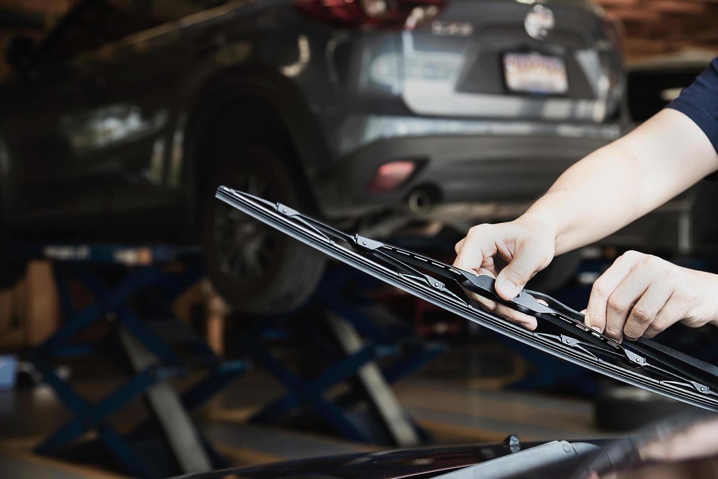 Man doing car wiper cleaning or changing maintenance - people with car maintenance concept photo