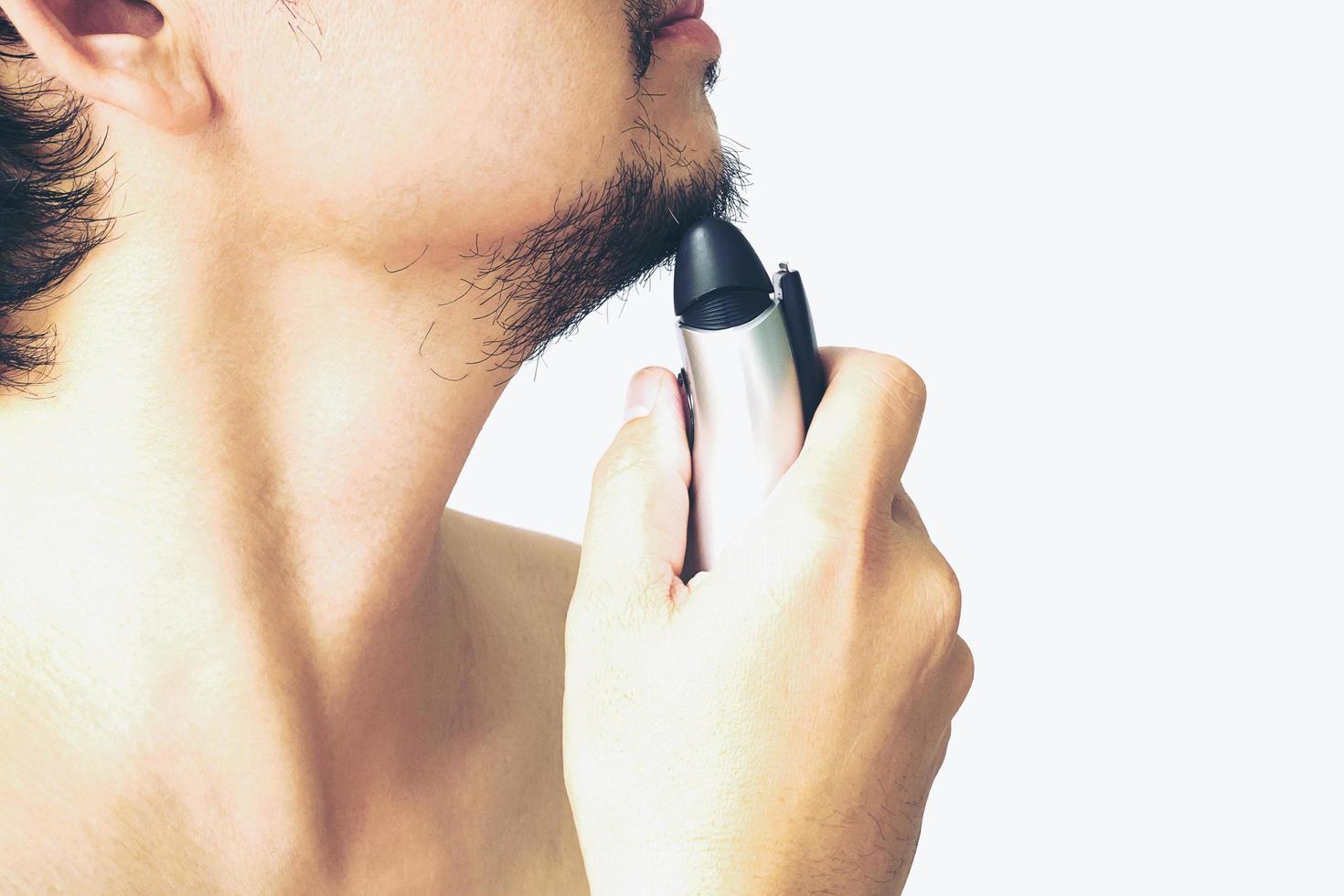 Man is using shaver photo