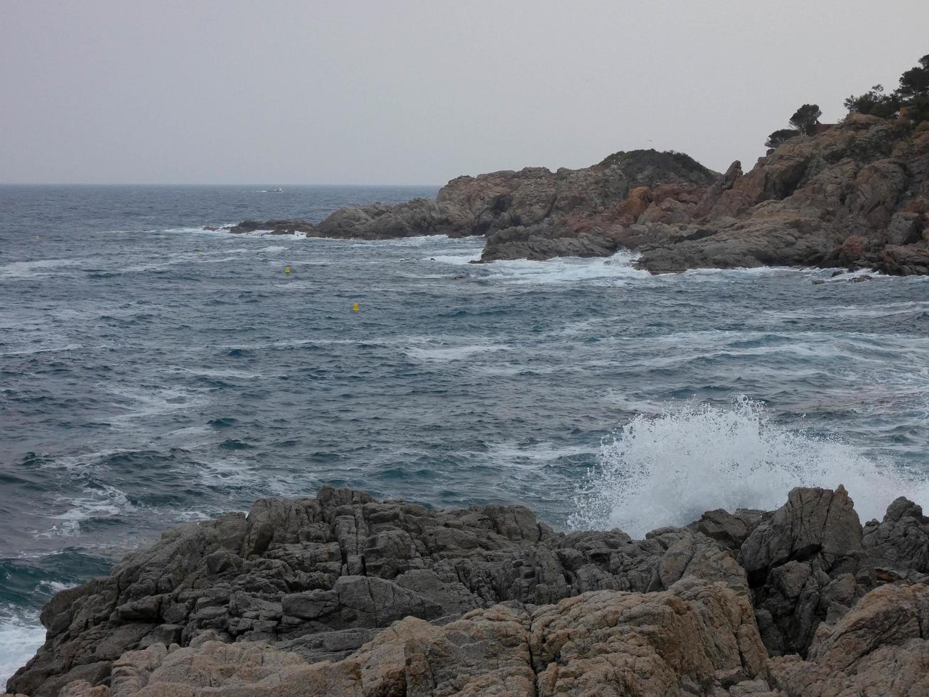 Rough sea, waves crashing against the rocks photo