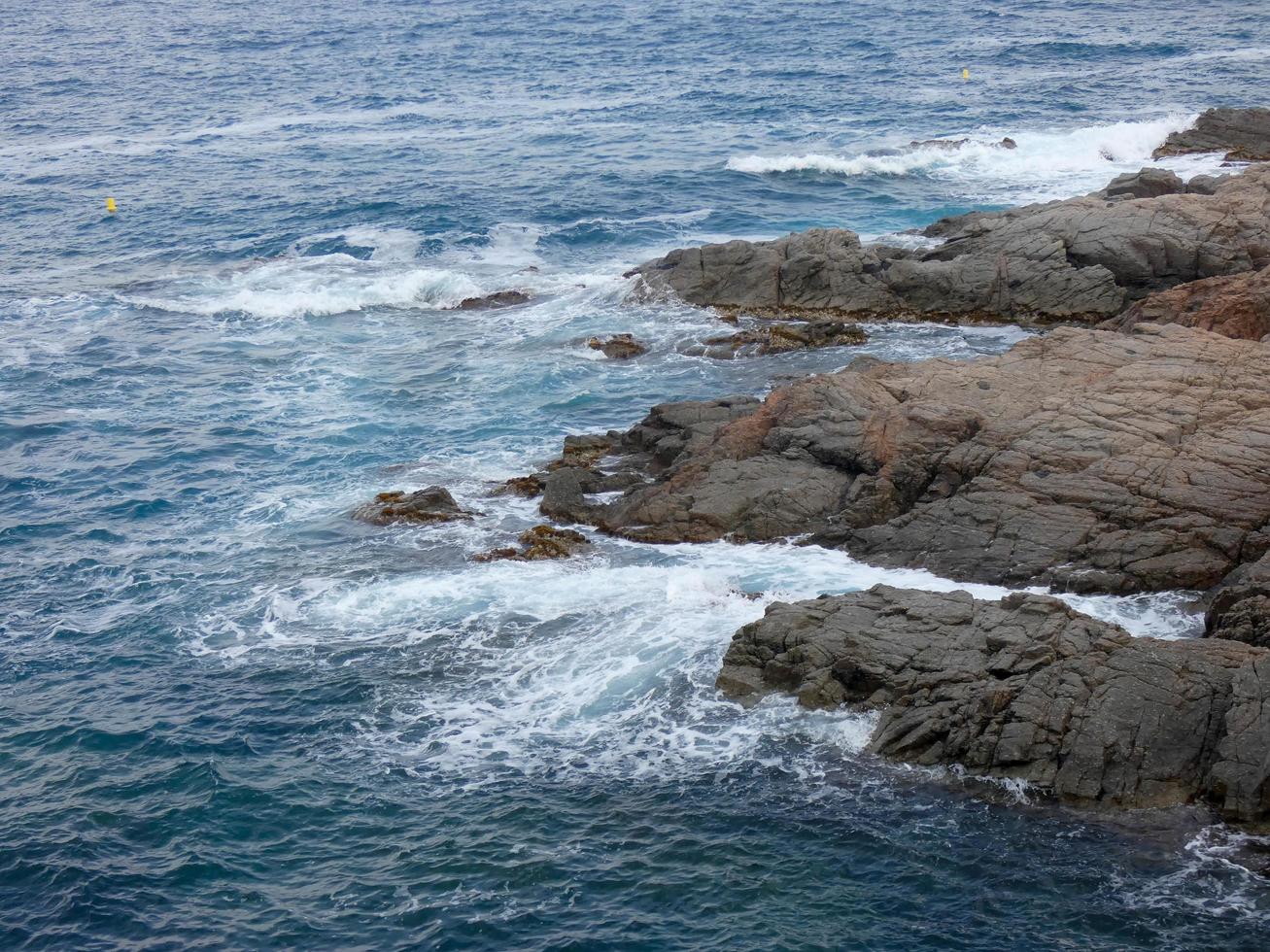 Rough sea, waves crashing against the rocks photo