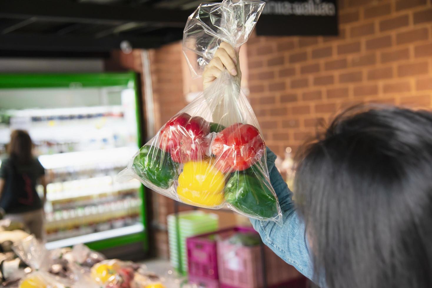 Lady is shopping fresh vegetable in supermarket store - woman in fresh market lifestyle concept photo