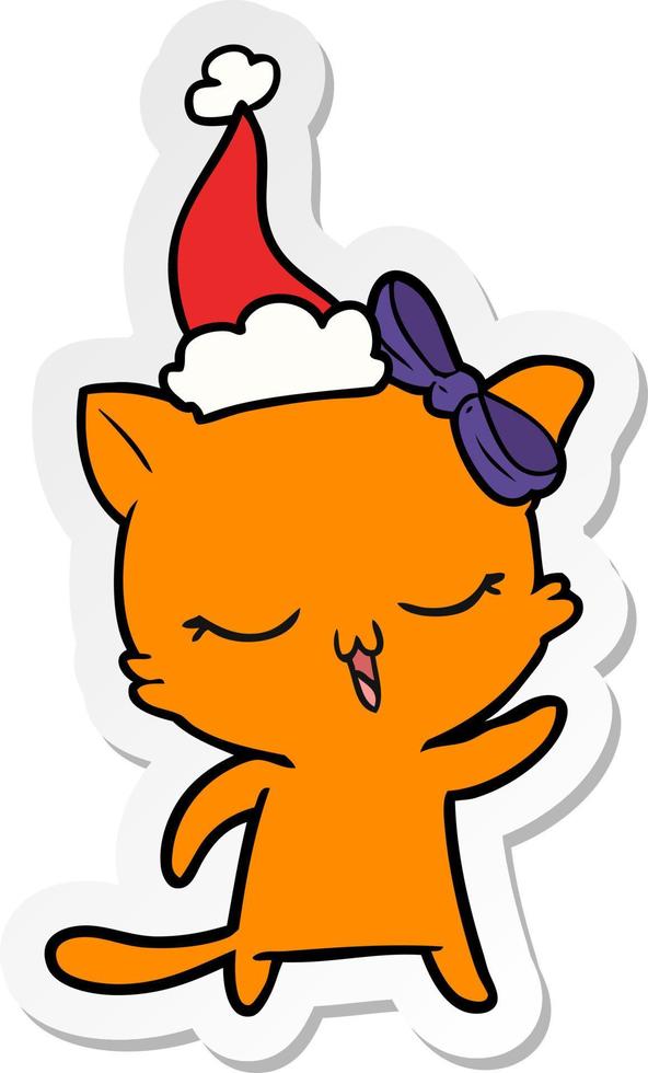 sticker cartoon of a cat with bow on head wearing santa hat vector