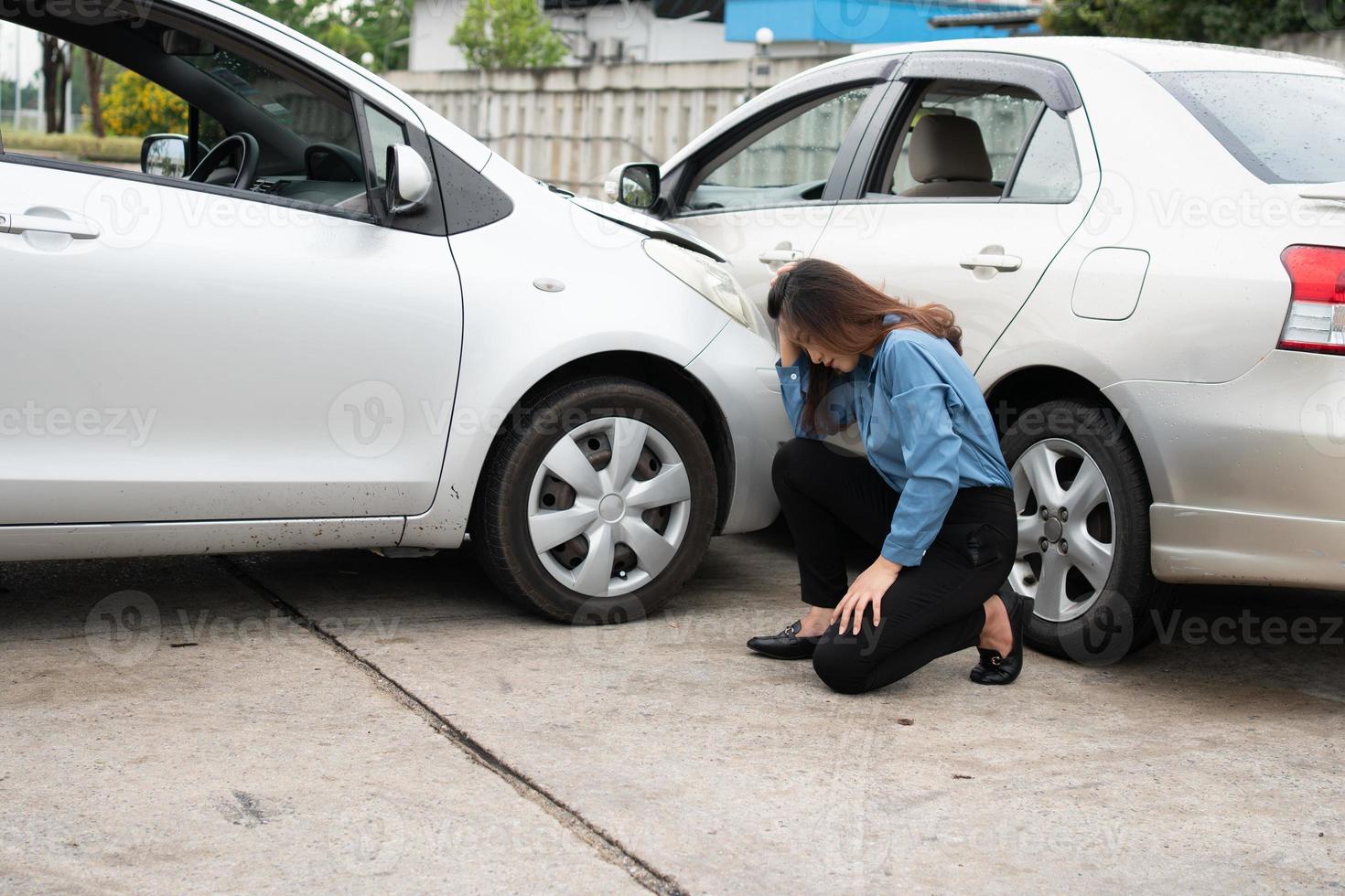 Women drivers sad after a car accident because not have car accident insurance. photo