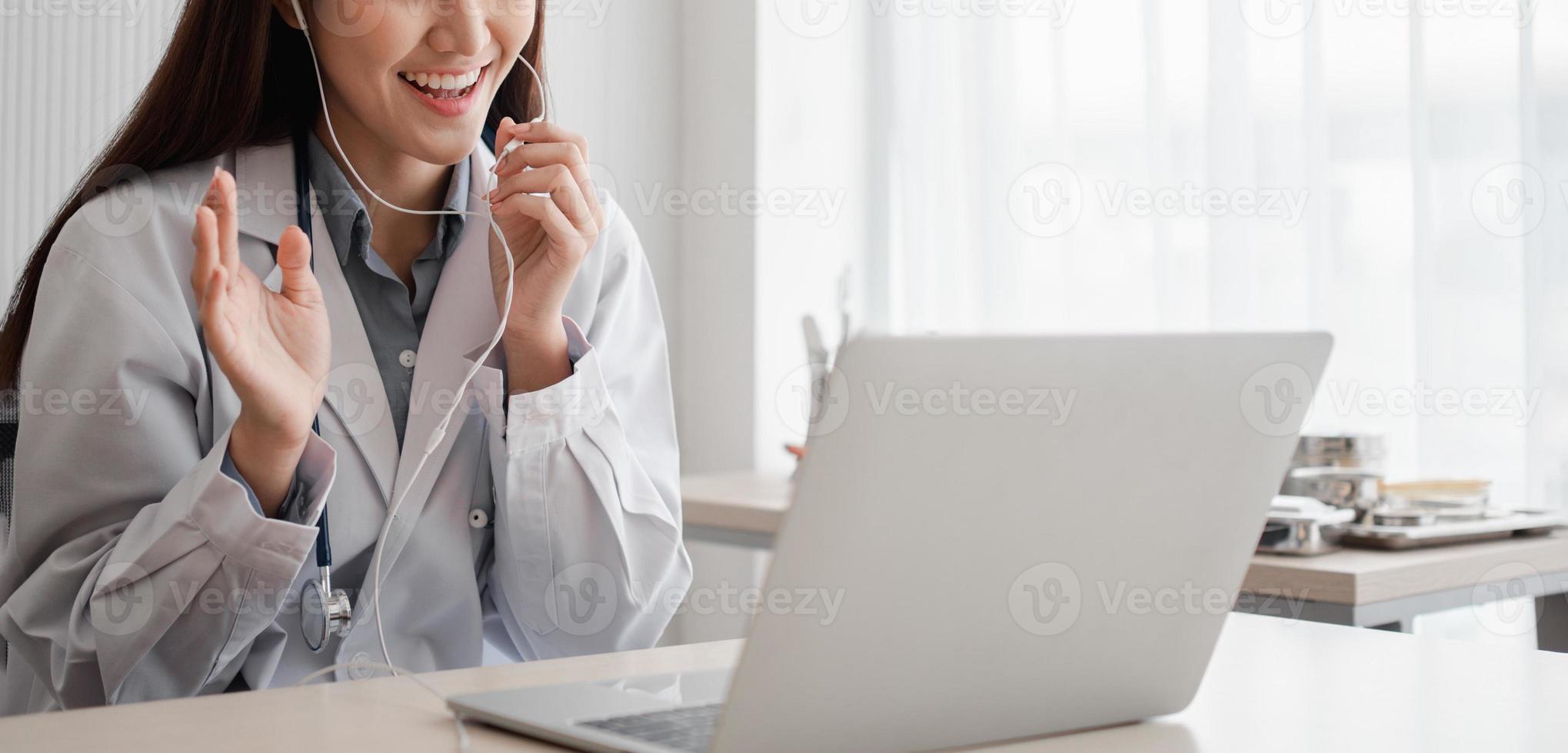 Asian woman doctor is online visiting with a patient on the internet application and Listening of the symptoms and explains how to treat the initial disease, Concept of Medical technology. photo