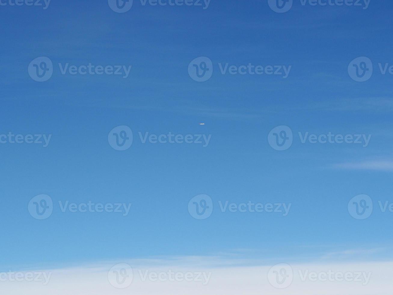Aerial view of cloudscape seen through airplane window photo