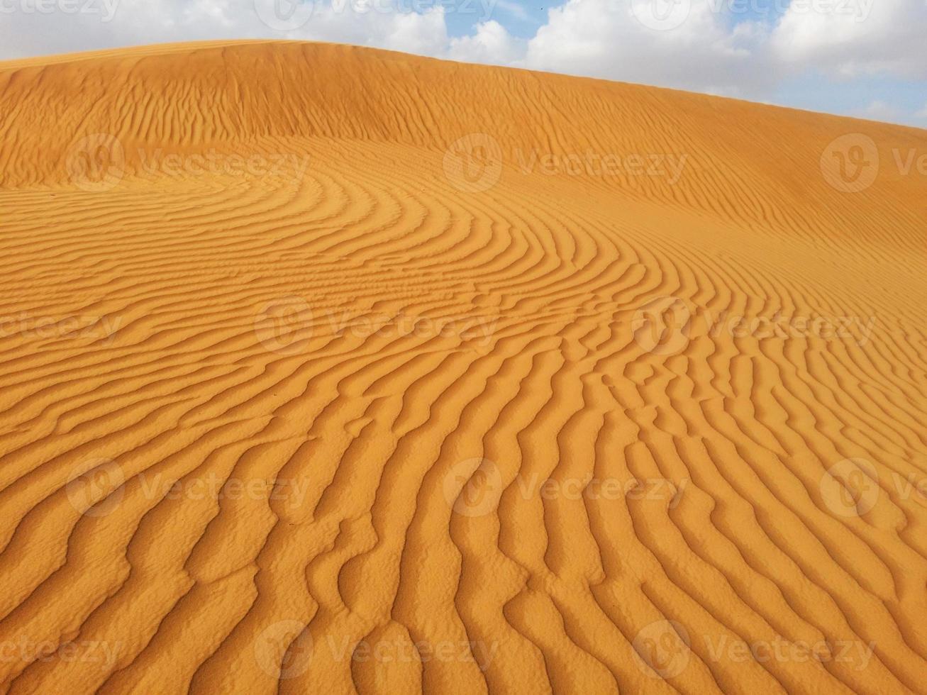 Sand dunes in the desert photo