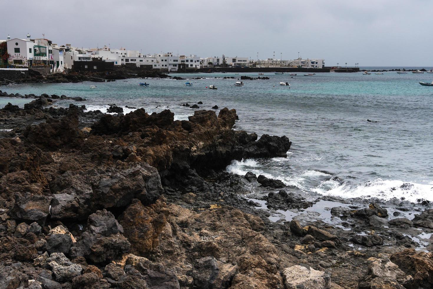 Lanzarote, Spain-August 7,2018-view of the small town of Punta Mujeres on the island of Lanzarote famous for its natural swimming pools during a cloudy day photo