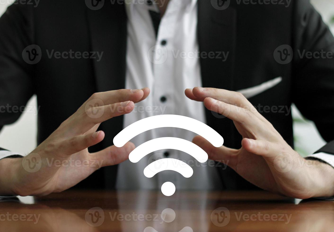 Businessman protects wireless network with hands photo