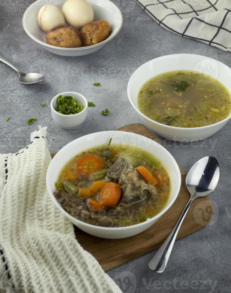 Indonesian food, beef ribs soup with mixed carrots and vegetables photo