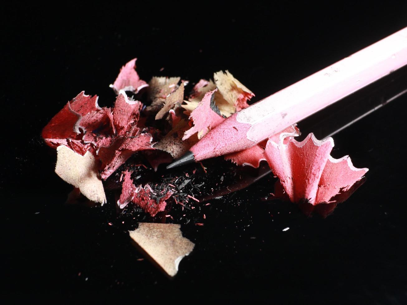 sharp pencil shavings on black background photo