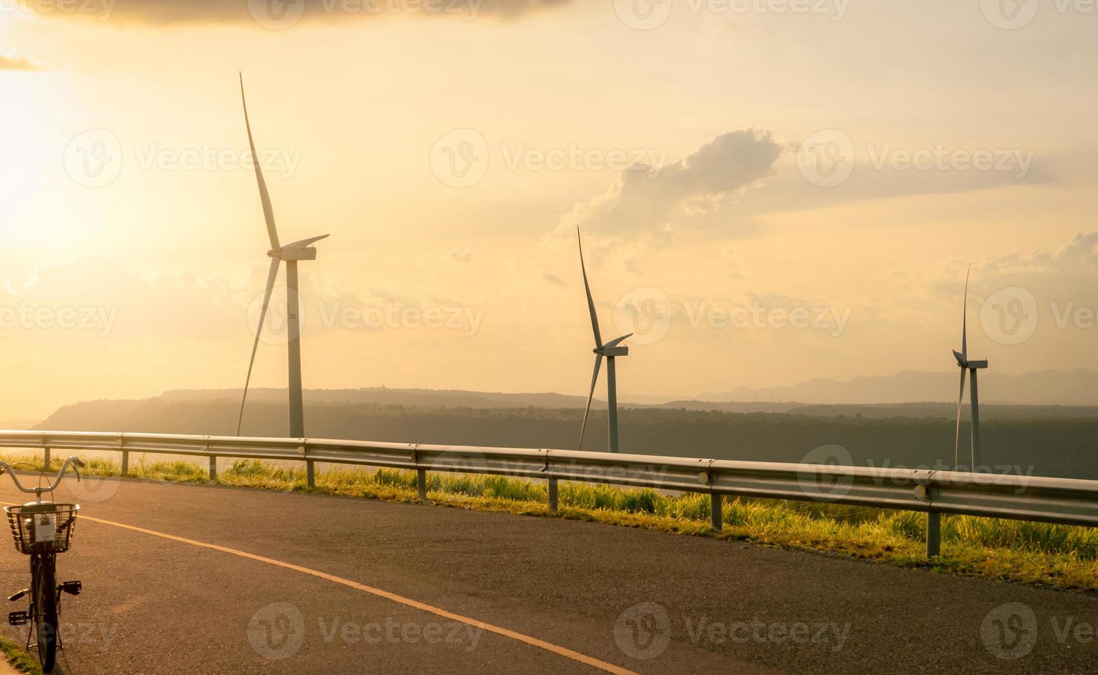 Wind energy. Wind power. Sustainable, renewable energy. Wind turbines generate electricity. Windmill farm on a mountain with blue sky. Green technology. Renewable resource. Sustainable development. photo