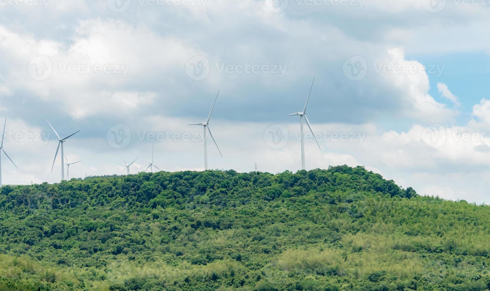 Wind energy. Wind power. Sustainable, renewable energy. Wind turbines generate electricity. Windmill farm on a mountain with blue sky. Green technology. Renewable resource. Sustainable development. photo
