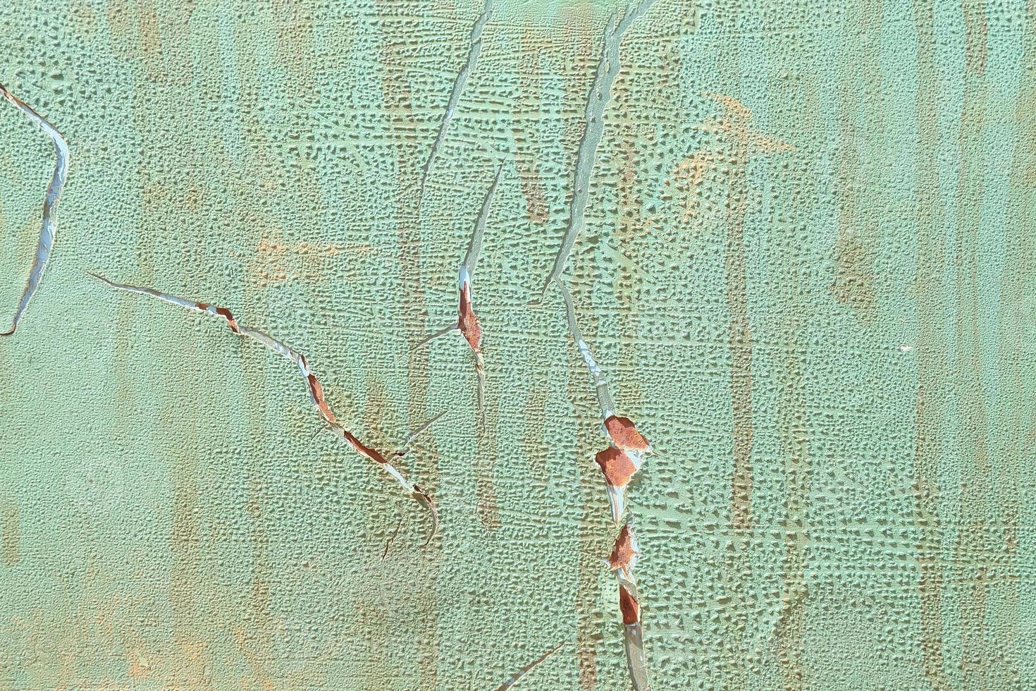 The surface of the broken color on car door, Green colored metal cracks background photo