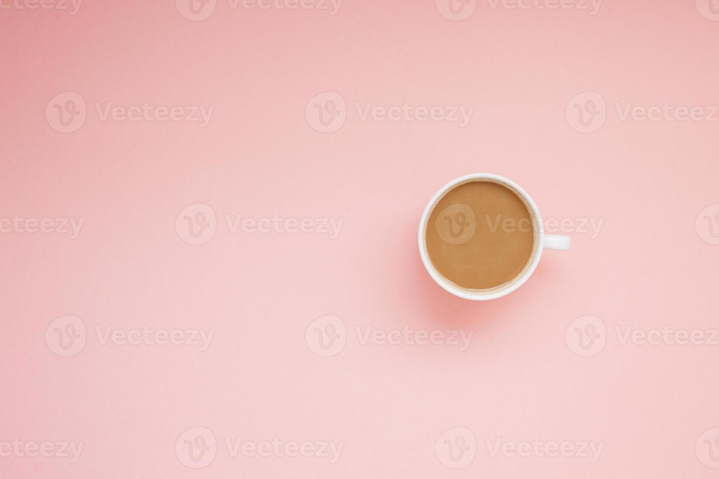 Cup of coffee with milk on pink background photo