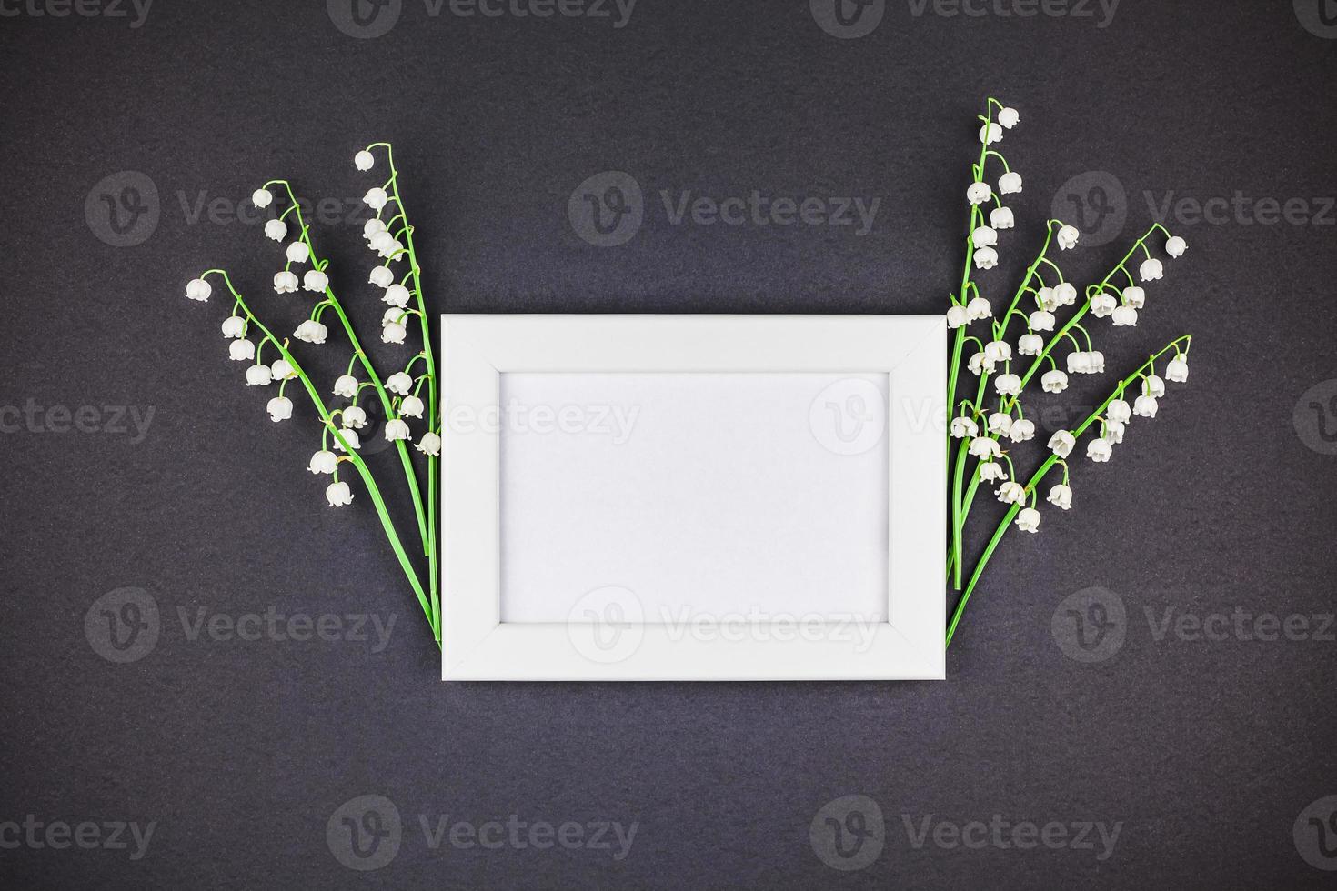 Frame mock up with bouquet of lilies of the valley photo