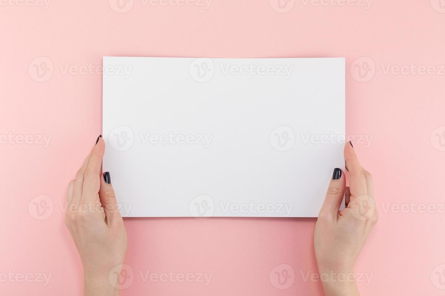 Woman hands with blank A4 paper sheet mockup photo