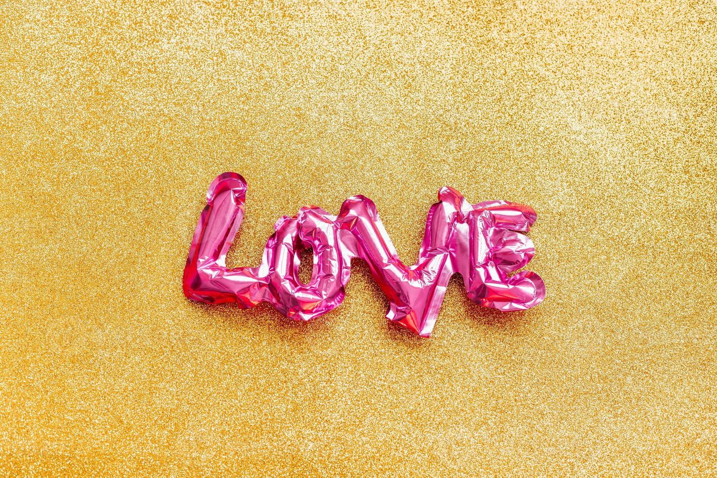 Love concept. Inflatable pink balloon with letters photo