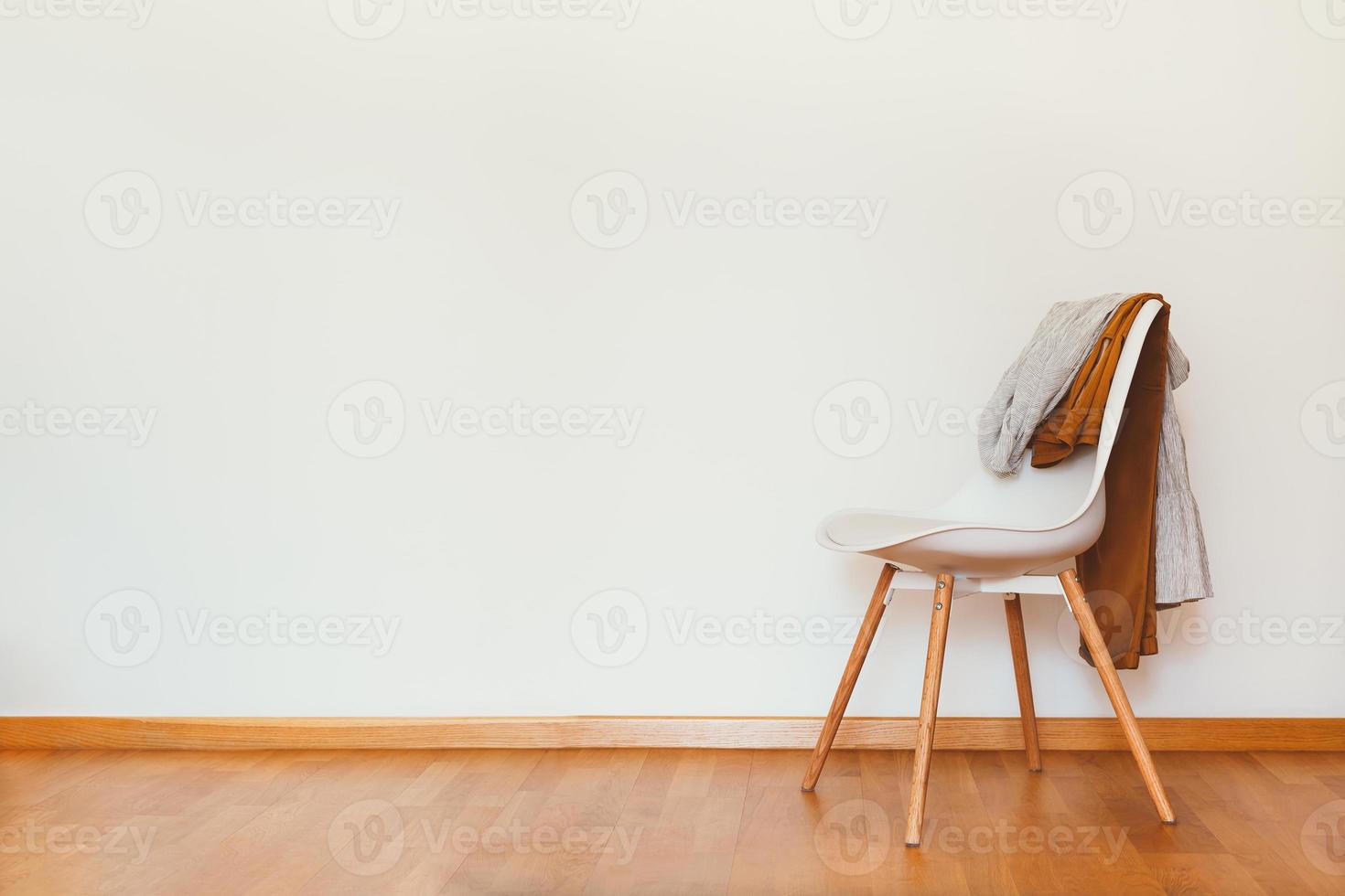 Indoors flat wall mockup with Clothes on Chair photo