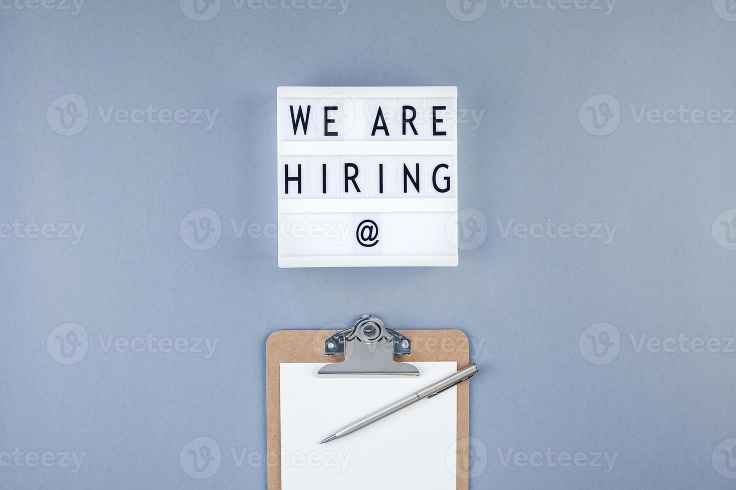 We are hiring flat lay on blue background photo