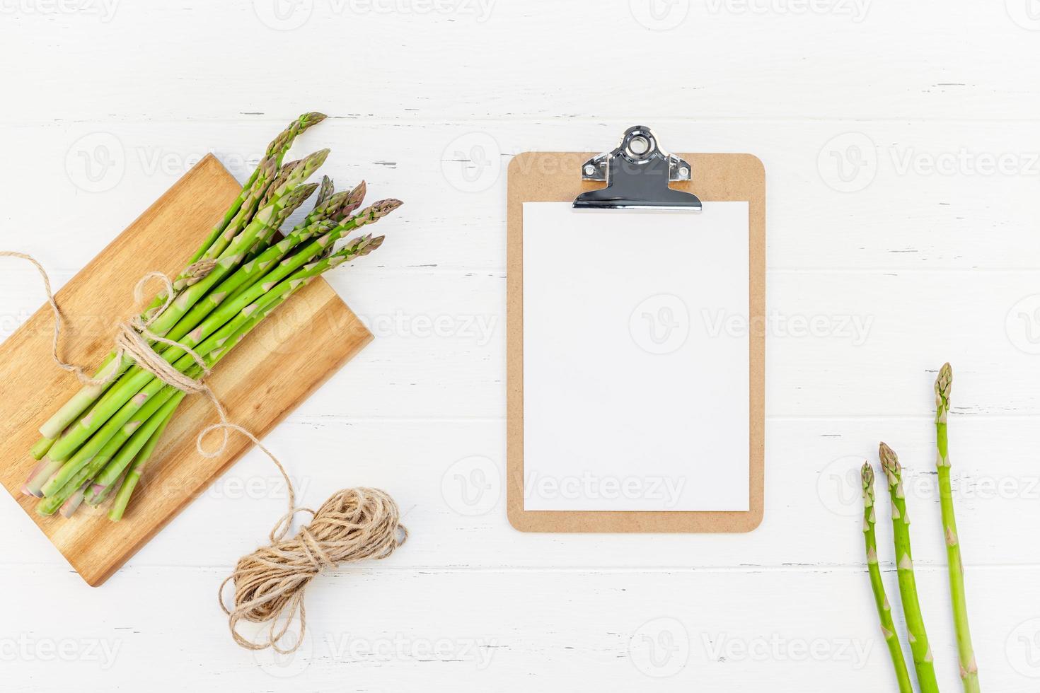 Fresh green asparagus with paper clipboard mockup photo