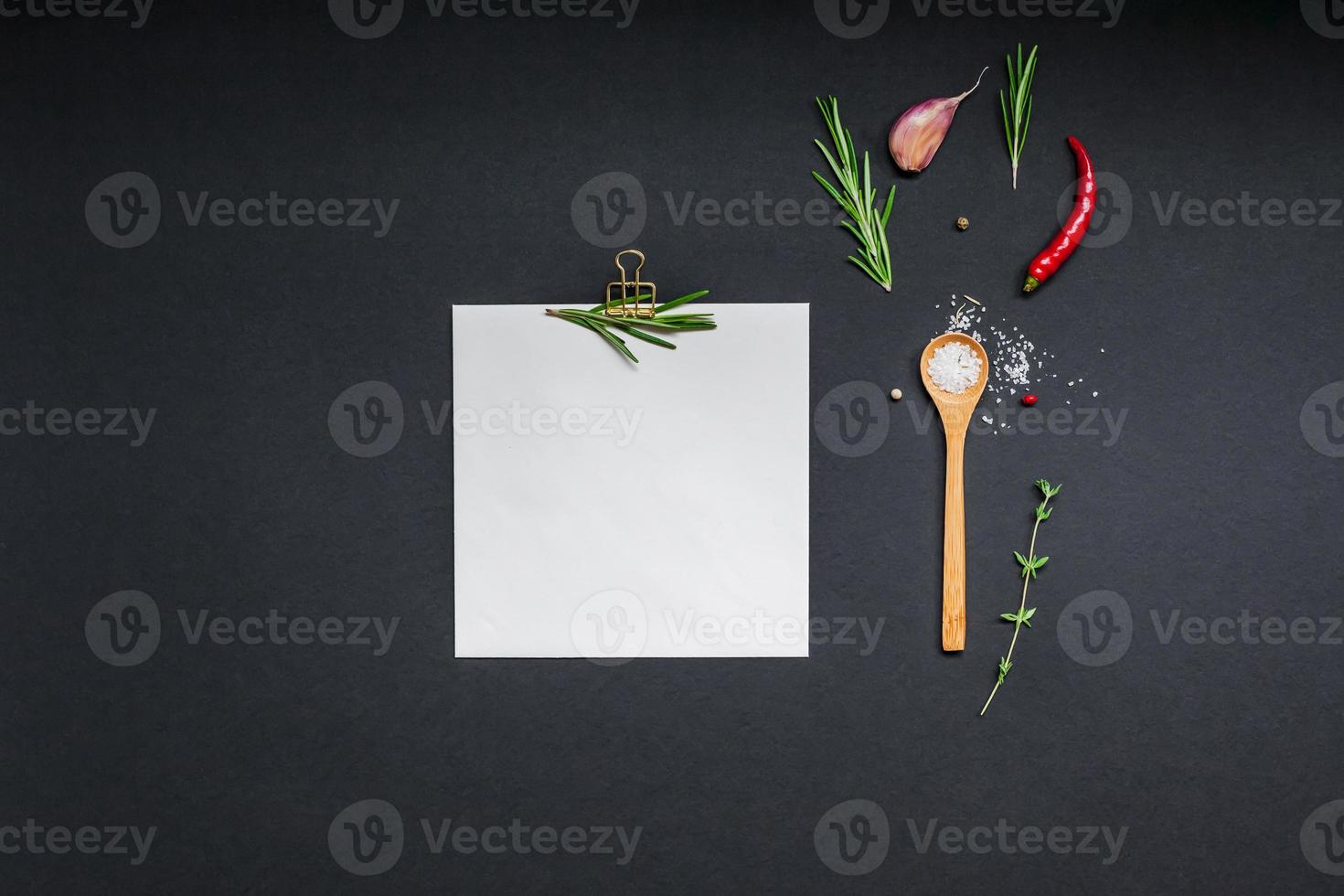 Blank notepad pages with greens herbs and spices photo