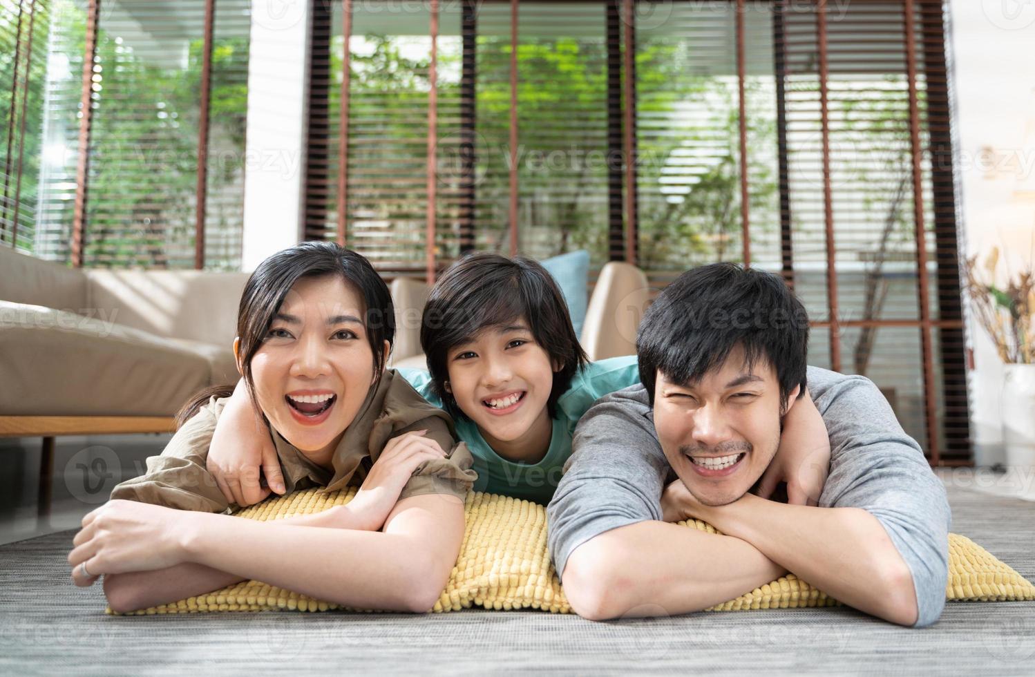 portrait of happy Asian family spending time together on sofa in living room. family and home concept. photo