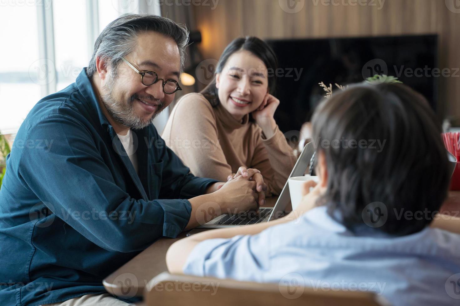 Happy Asian family spending time together in living room. family and home concept. photo