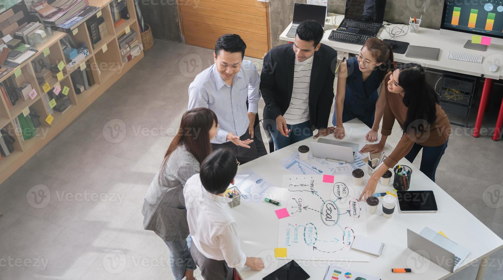 Group of Asian business people team meeting in modern office working design planning and ideas concept photo