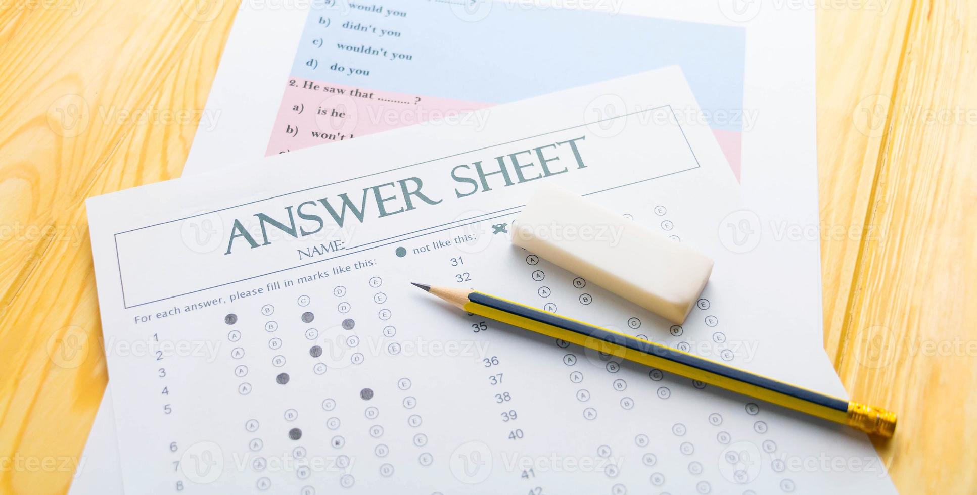 pencil on answer sheet and question sheet photo