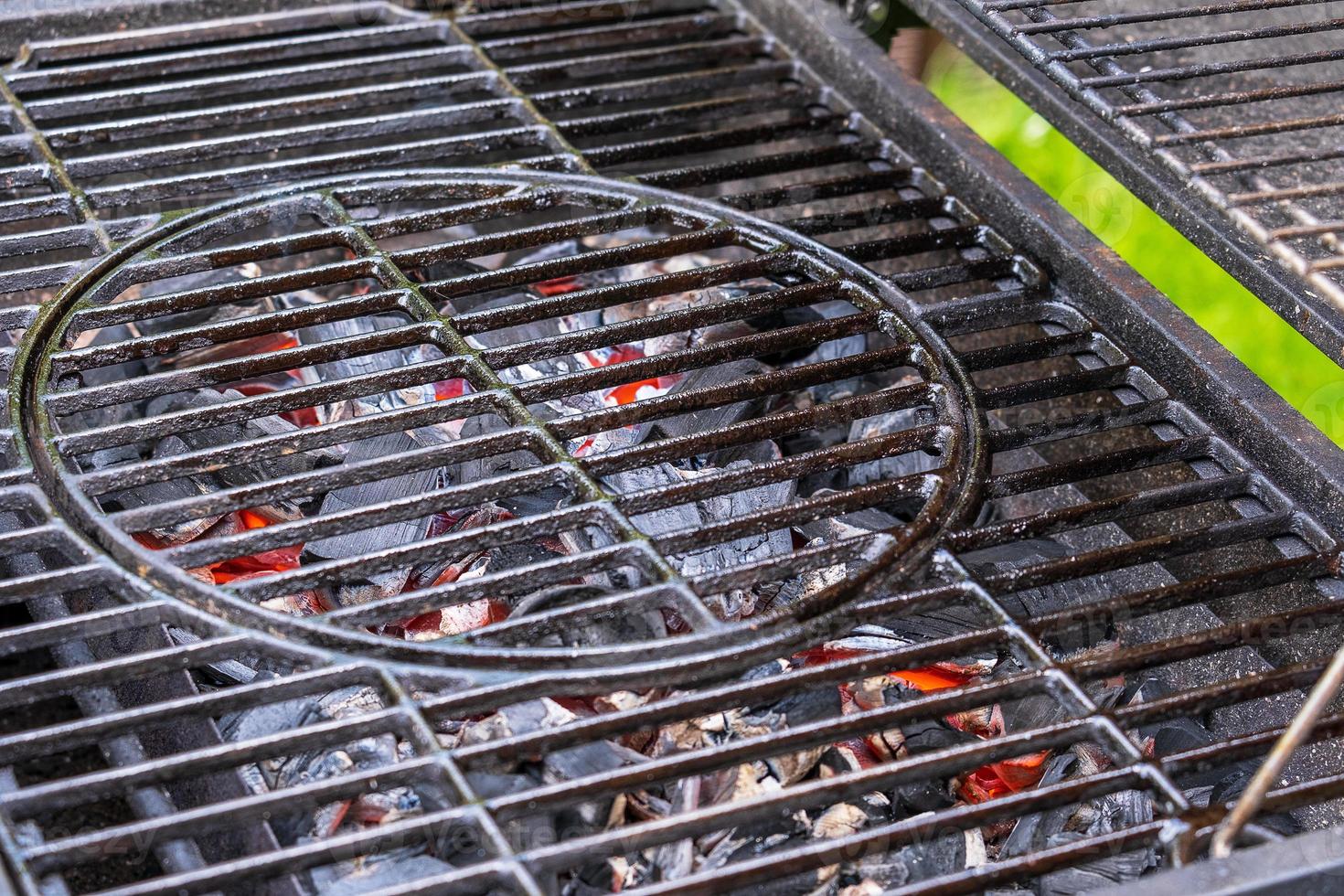 Barbecue device with grill grate. Hot coals for cooking steaks. photo