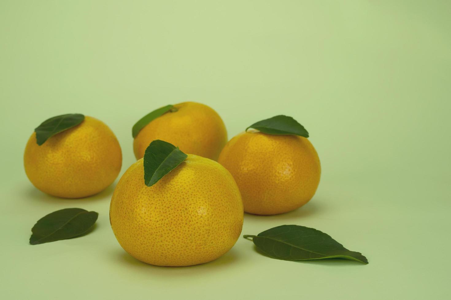 Fresh juicy orange fruit set over light green background - tropical orange fruit for background use photo