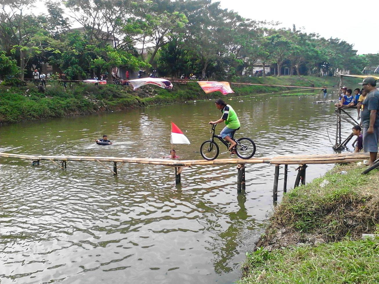 Tulungagung, Jawa timur, Indonesia, 2022 - august bicycle race running on a board across the river photo