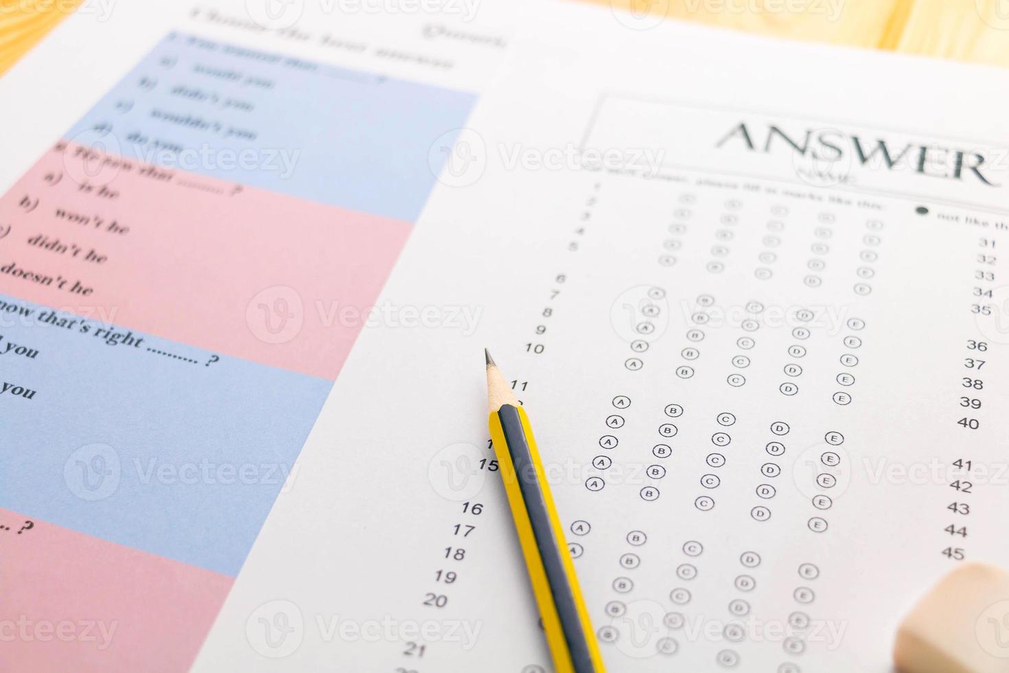 pencil on answer sheet and question sheet photo