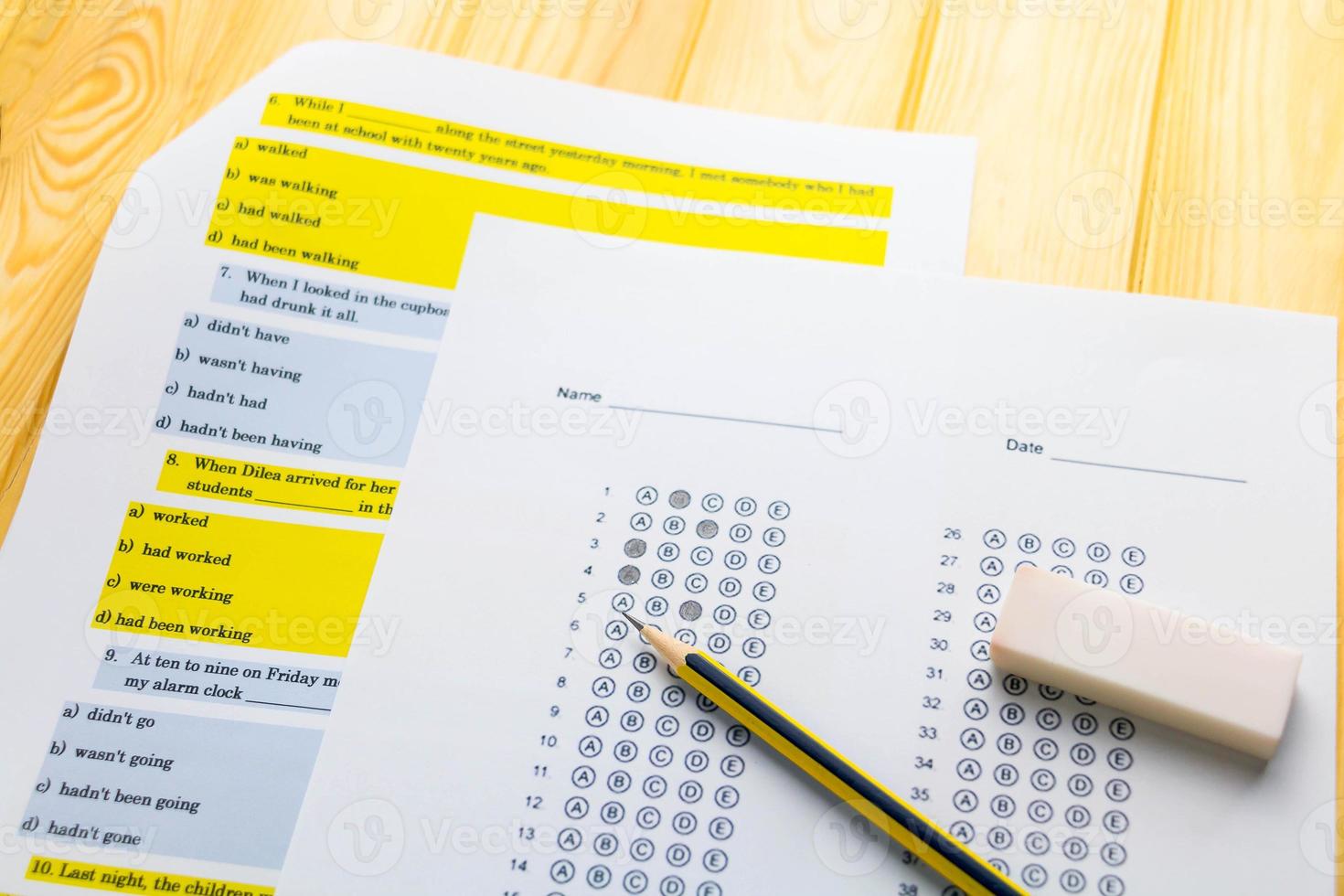 pencil on answer sheet and question sheet photo