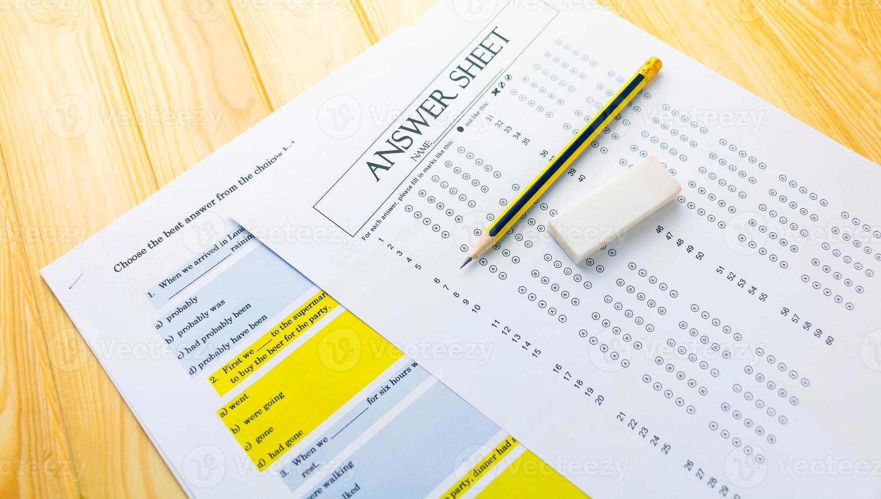 pencil on answer sheet and question sheet photo