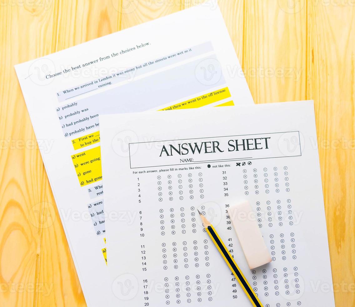 pencil on answer sheet and question sheet photo