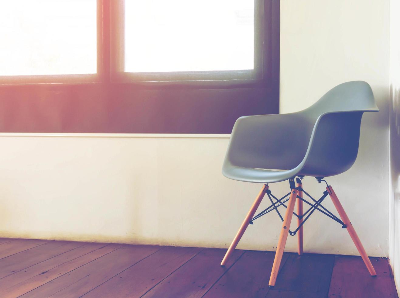 chair by window in room with gradient light photo