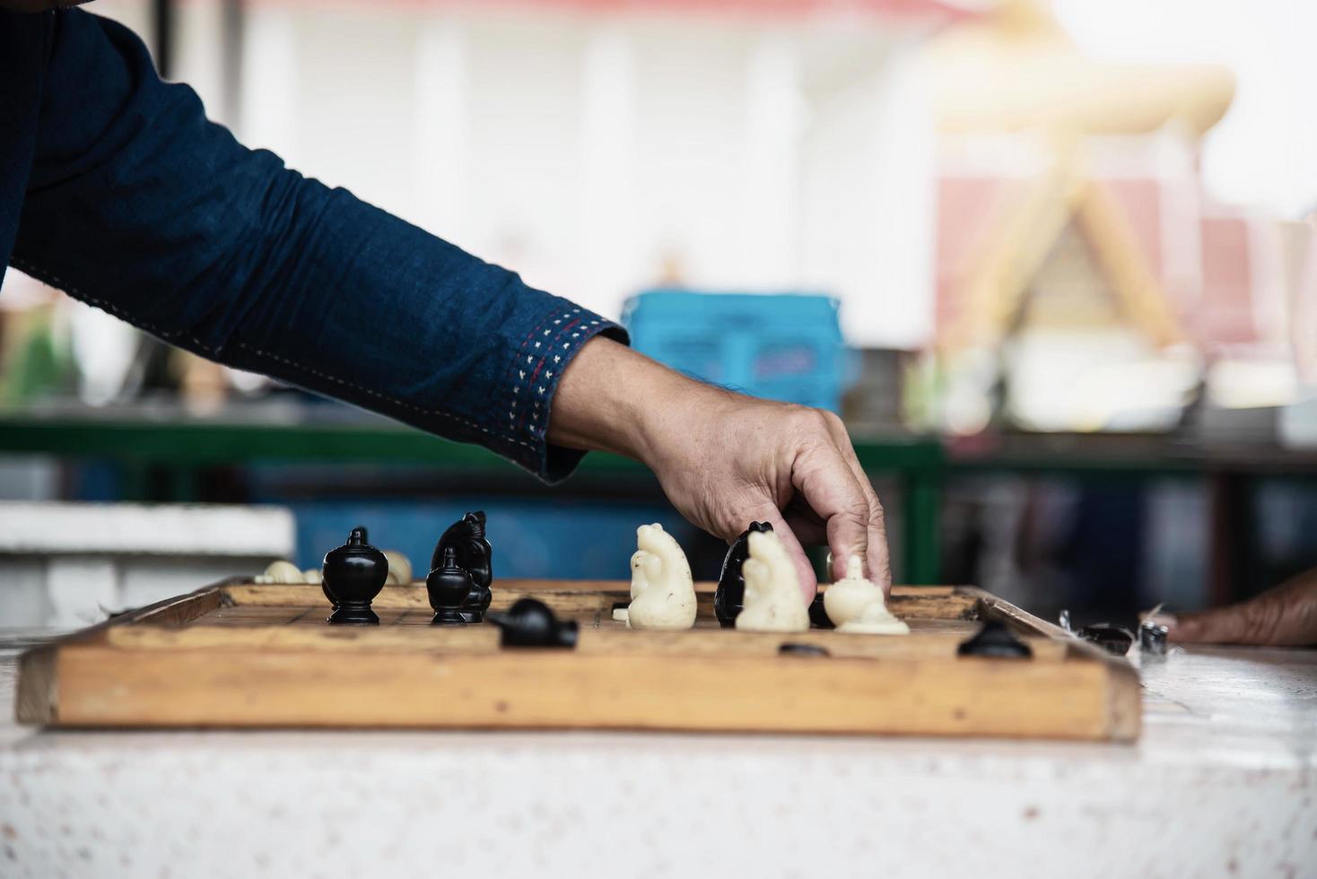 Local Thai people play old traditional Thai chess in public area - slow life style local people with chess board game concept photo