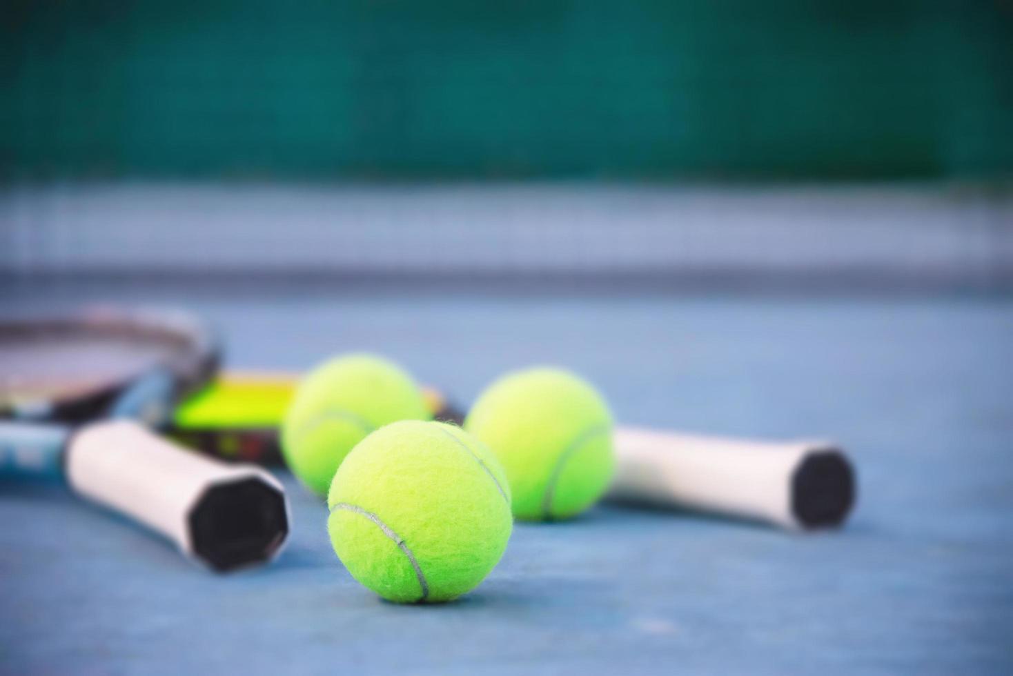 Tennis racket with ball on blue hard court with nobody - tennis sport background concept photo