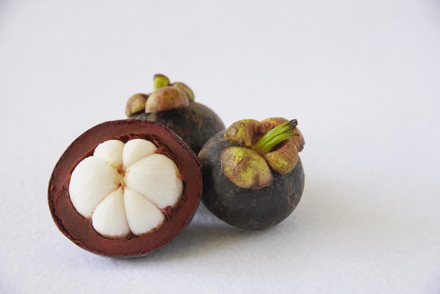 Mangosteen Thai popular fruits - a tropical fruit with sweet juicy white segments of flesh inside a thick reddish-brown rind. photo