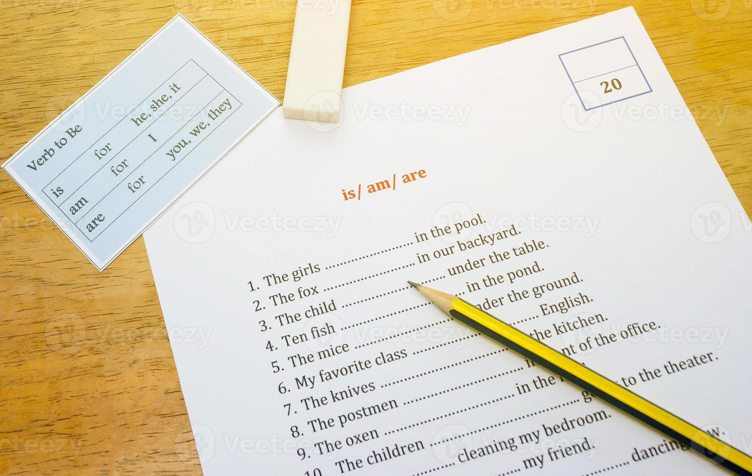 english exercise on brown wooden desk with gradient light photo