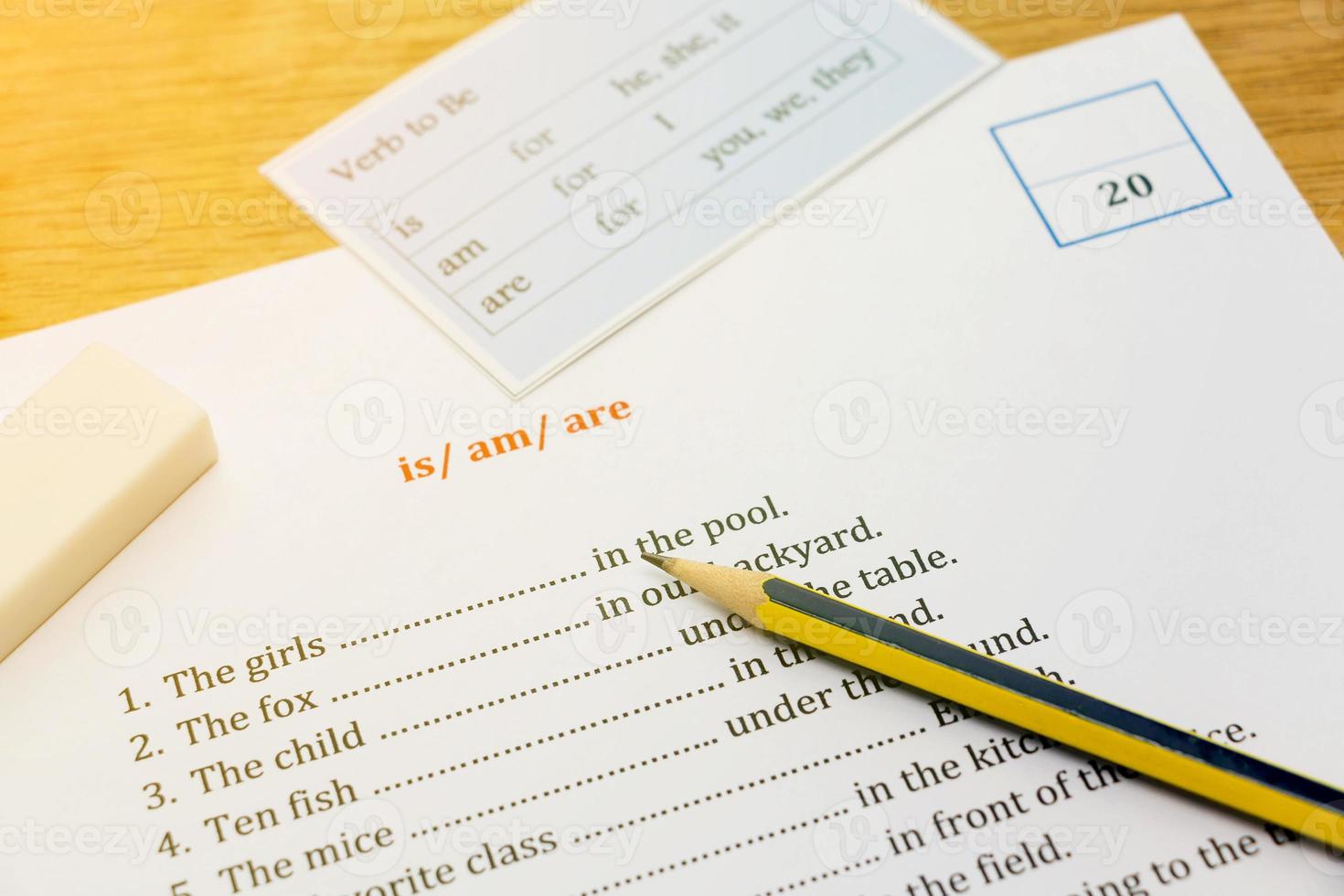 english exercise on brown wooden desk with gradient light photo