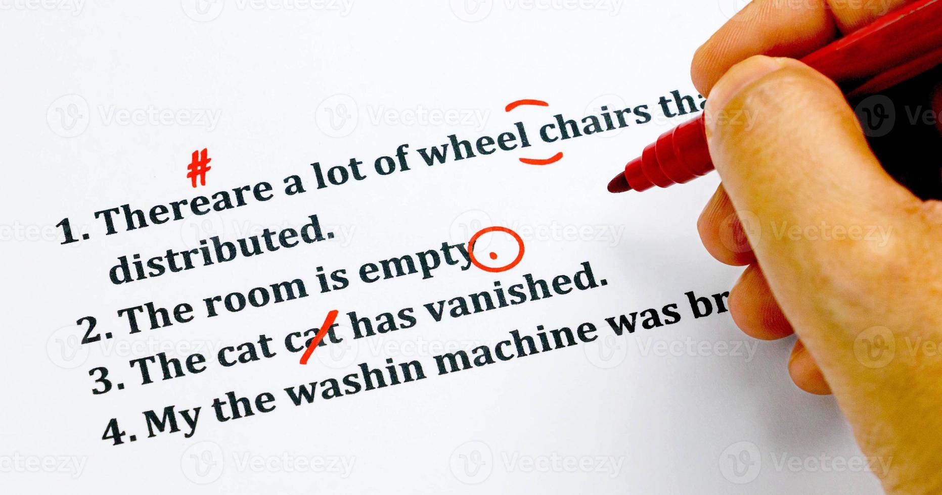english sentences and correcting symbols on white sheet photo