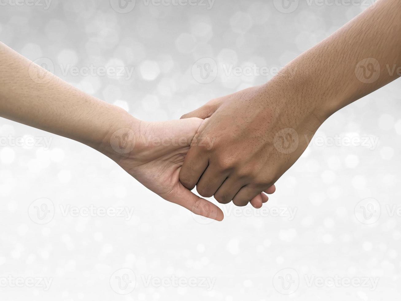 Image of a couple holding hands on shining bokeh background photo