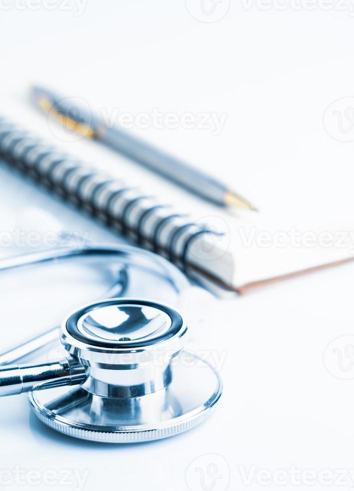 Medical stethoscope with blank notepad photo