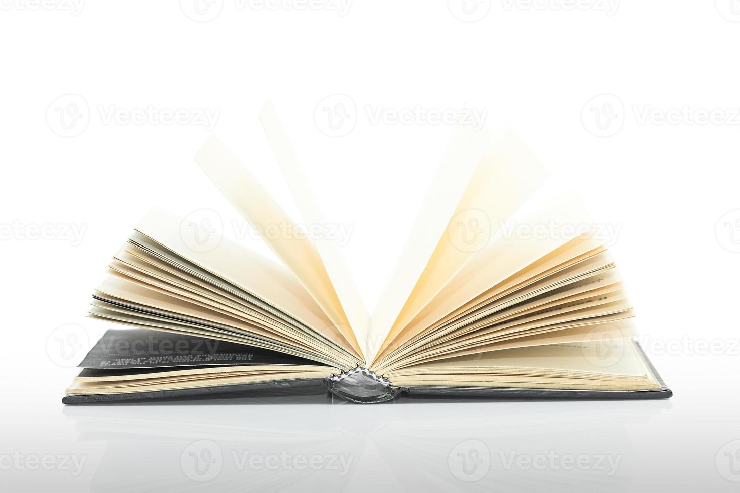 Open black book with shadow on white background photo