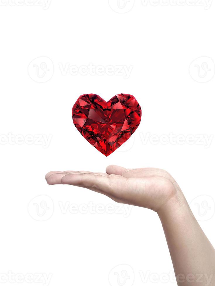 Hand holding red heart shaped diamond isolated on white background photo