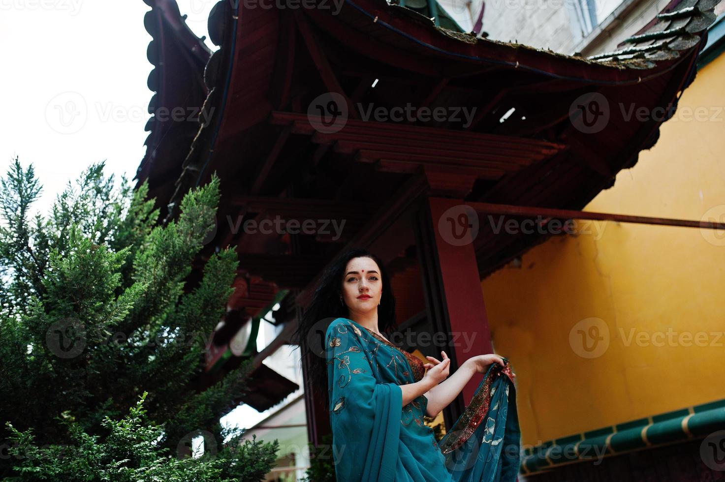 Portrait of beautiful indian brumette girl or hindu woman model against japanese traditional house. photo