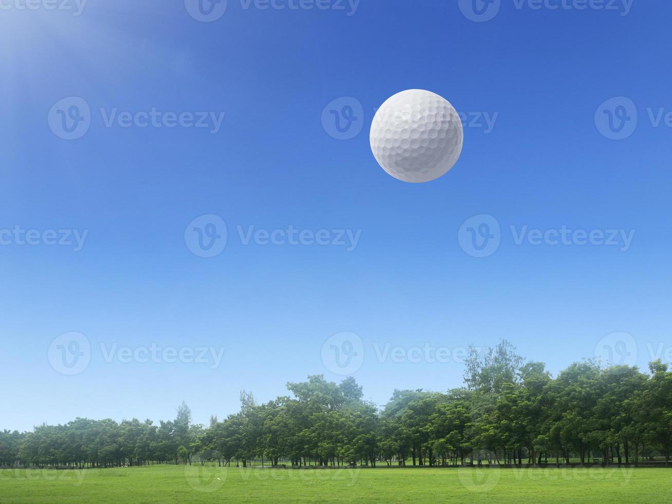 Golf ball floating in the air on a golf course photo