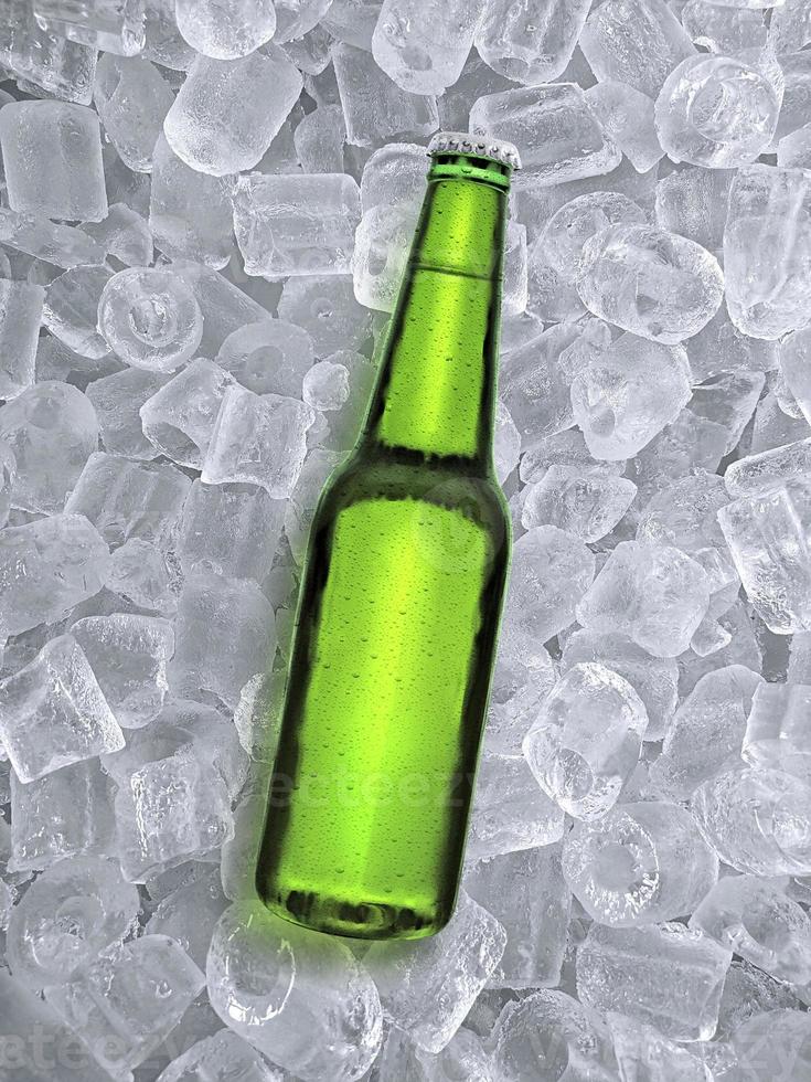 Beer bottle with water drops of cold beverage, ice cube a of juicy. Summer refreshing drink photo